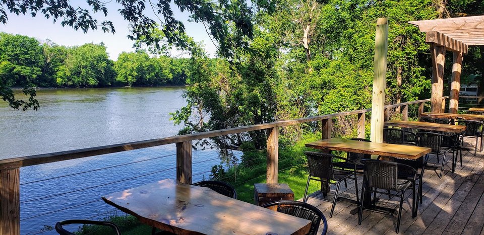 Serene riverfront restaurant exterior.